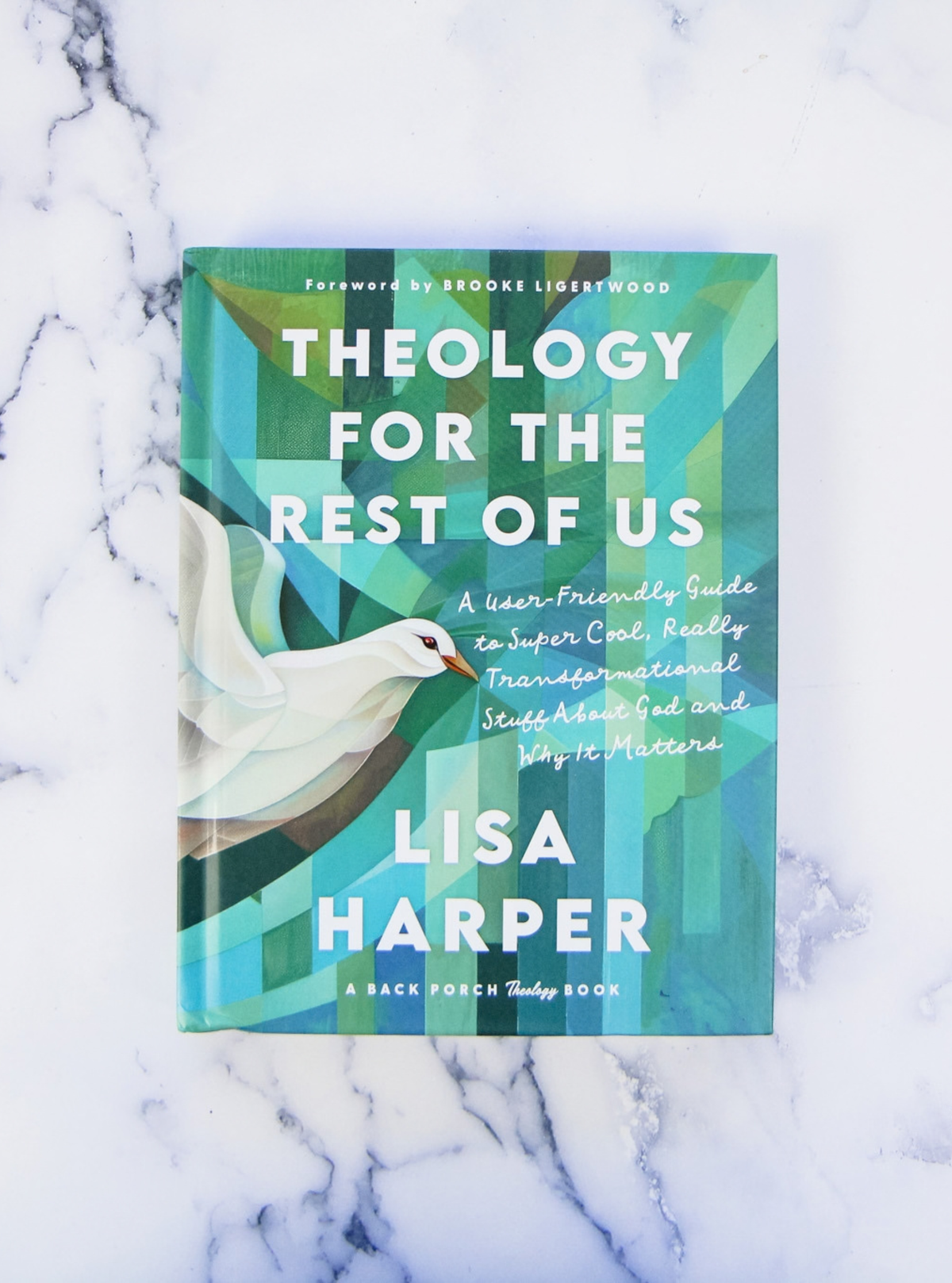 Cover of "Theology for the Rest of Us" on a marble countertop.